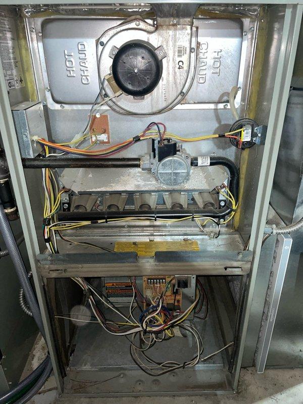 Responded to no cooling condition on downstairs air conditioning system. Upon arrival, confirmed thermostat was clicking but outdoor condensing unit failed to activate. Performed system diagnostics and inspected furnace cabinet interior components including gas valve assembly, burner manifold, control board, and blower motor housing. Verified thermostat wiring connections and tested control voltage at air handler. Checked return air ductwork and flexible duct connections for proper airflow pathway. System restored to normal operation with outdoor unit now responding to thermostat calls for cooling.