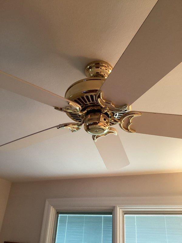 Responded to service call for ceiling fan with broken pull chain switch operating at maximum speed only. Inspected brass-finished ceiling fan with decorative housing and confirmed pull chain mechanism failure preventing speed control adjustment. Assessed fan motor housing and wiring connections to determine repair feasibility versus replacement options. Provided customer with evaluation findings and recommendations for restoring proper fan operation and speed control functionality.