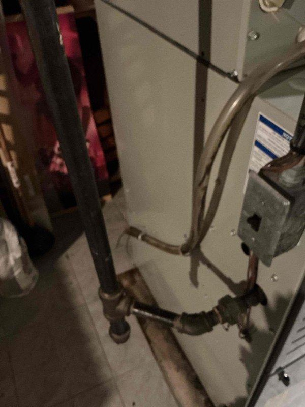 Responded to water leak complaint in basement around HVAC equipment. Upon inspection, discovered clogged condensate drain line causing water overflow and accumulation on floor. Cleared blockage from drain line, removing accumulated debris and sediment that had restricted proper drainage. Verified condensate system flowing freely and tested equipment operation to ensure proper function. Cleaned up water and debris from floor area surrounding unit.
