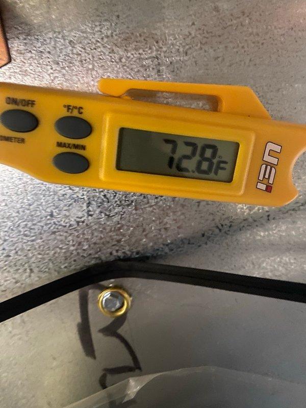 Completed routine cooling season tune-up on residential air conditioning unit located on side of home. Performed standard maintenance protocol including temperature diagnostics showing 72.8°F supply air reading, inspected condenser unit exterior components, and documented significant debris accumulation and biological growth on lower coil section requiring attention. Unit operational at time of service with adequate condensation present on evaporator components indicating active cooling cycle.