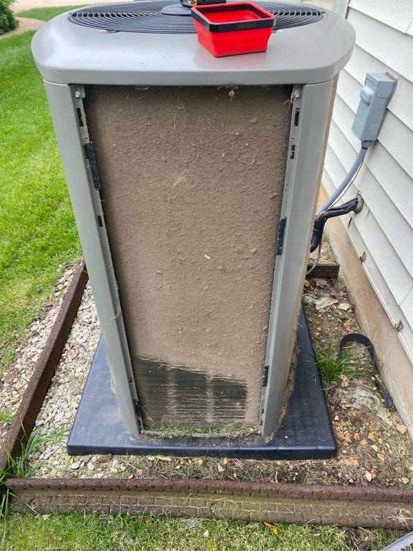 Completed routine cooling season tune-up on residential air conditioning unit located on side of home. Performed standard maintenance protocol including temperature diagnostics showing 72.8°F supply air reading, inspected condenser unit exterior components, and documented significant debris accumulation and biological growth on lower coil section requiring attention. Unit operational at time of service with adequate condensation present on evaporator components indicating active cooling cycle.