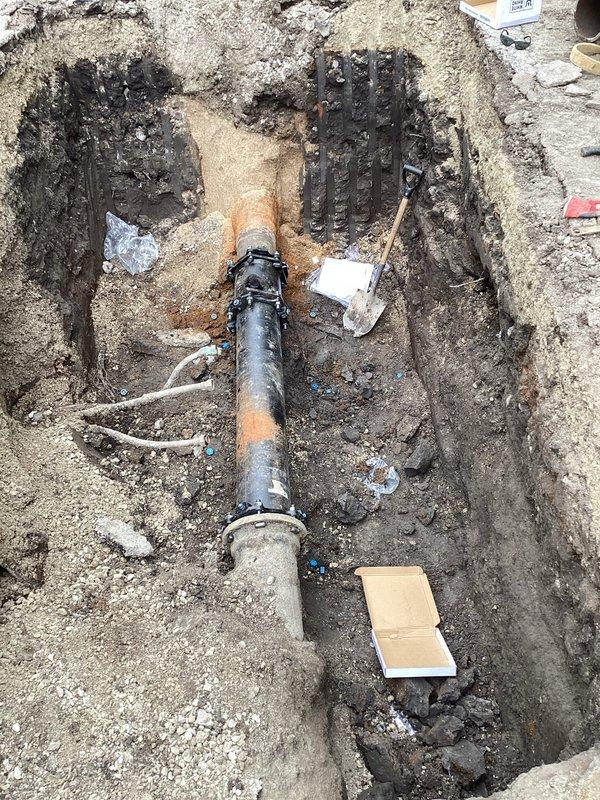 Performed water service line repair involving excavation and replacement of severely corroded piping. Excavated trench to expose existing black industrial water service pipe that exhibited extensive rust, corrosion, and structural deterioration throughout its length. Removed compromised pipe section from trench, which showed significant pitting, oxidation, and surface degradation due to prolonged exposure to moisture and soil conditions. Replaced deteriorated piping with new water service line to restore proper water delivery and prevent service interruption. Backfilled excavation upon completion of installation.