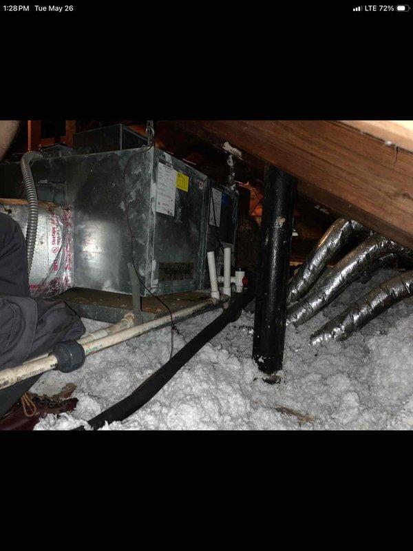 Responded to no-cool call on 12-year-old Unico high-velocity system located in attic with outdoor unit not running despite indoor fan operation and history of coil/line blockages that previous companies were unable to resolve. Accessed attic via pull-down ladder, inspected air handler and associated ductwork, and documented equipment condition with photos for further diagnostic assessment.