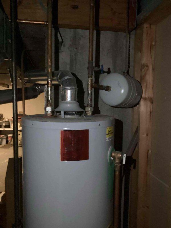 Installed a new 40-gallon tall gas water heater in basement utility area, including all necessary plumbing connections with copper piping, thermal expansion tank, and required safety valves. Unit was properly vented, tested for proper operation, and all connections were verified leak-free upon completion.