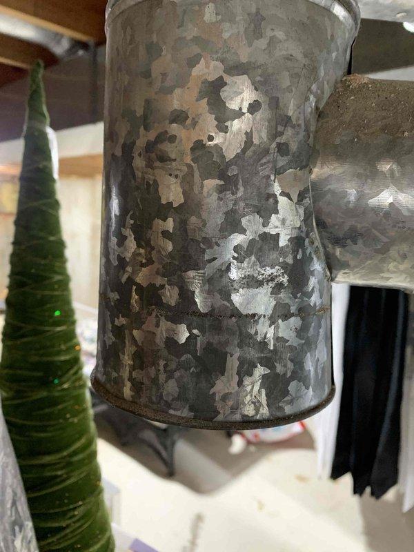 Responded to no cooling complaint on 18+ year old system. Upon arrival, unit was off as reported. Conducted comprehensive diagnostic evaluation of HVAC system and ductwork. Inspection revealed severely deteriorated galvanized ductwork with extensive surface corrosion, flaking zinc coating, and compromised metal integrity throughout multiple sections. The supply duct exhibited significant paint and coating degradation with rust penetration and structural concerns. Documented deteriorated ductwork conditions with photographs showing mottled surface patterns, exposed base metal, and areas of complete coating failure. Assessed system components and identified ductwork replacement as critical need due to age-related deterioration affecting system efficiency and air quality. Presented findings and repair recommendations to property representative who had authorization to approve necessary work. System requires ductwork replacement to restore proper operation and resolve cooling deficiency.