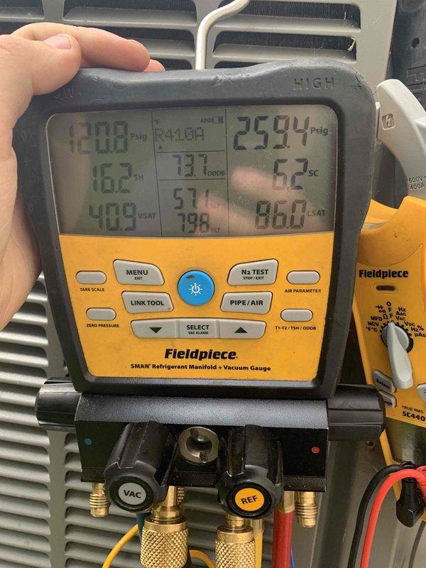 Completed comprehensive cooling system tune-up on single outdoor AC unit located at side of home. Performed refrigerant pressure and temperature diagnostics using digital manifold gauge, confirming system pressures at 25.94 PSIG with superheat readings at 62°F and saturated temperatures within normal operating parameters. Inspected blower wheel assembly, verified clean condition of squirrel cage fan blades with no debris accumulation, and confirmed proper motor shaft alignment and operational integrity of centrifugal blower components.