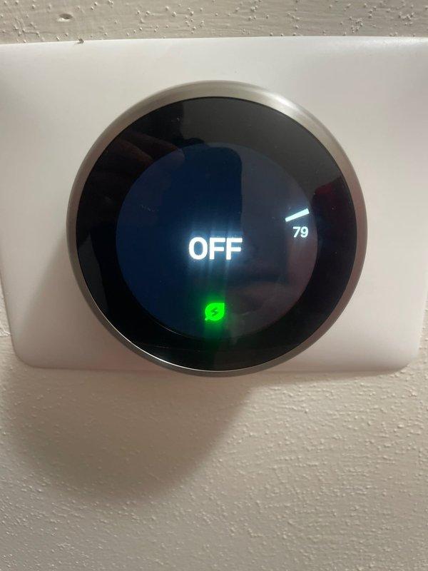 Responded to no cooling complaint on 5-year-old ground-level unit reported to be blowing warm air. Upon arrival, verified thermostat was initially in OFF position showing 79°F ambient temperature. Cycled system into cooling mode and confirmed unit successfully achieved cooling operation with thermostat displaying 73°F setpoint and active cooling status. System operating normally with no freezing observed on coils and proper airflow established.