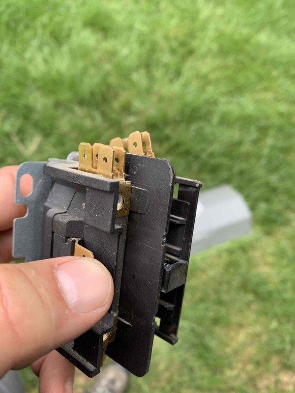 Responded to no cooling call on U10 unit located at side of home following multiple previous service visits. Upon inspection, diagnosed failed contactor relay preventing unit from energizing. Removed defective contactor assembly showing signs of electrical wear and oxidation on brass terminals and replaced with new component to restore proper operation and cooling function.