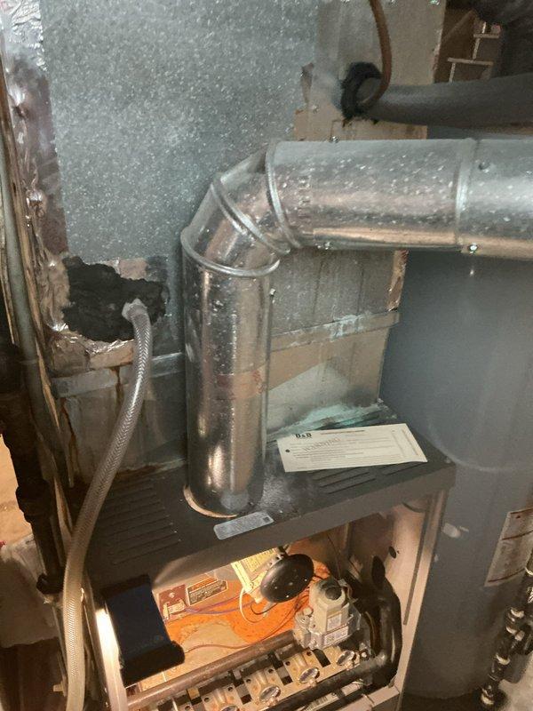 Responded to no-cooling complaint on residential system over 20 years old. Performed comprehensive diagnostic evaluation of single-zone HVAC system including outdoor condensing unit located in side yard and indoor air handler in basement utility area. Inspected refrigerant lines, electrical connections, and overall system operation. Documented equipment condition with photos showing aged outdoor unit on concrete pad and indoor components with visible ductwork and condensate drainage. Provided second opinion assessment on system's inability to maintain desired temperature setpoint and discussed findings with homeowner regarding performance limitations of aging equipment.