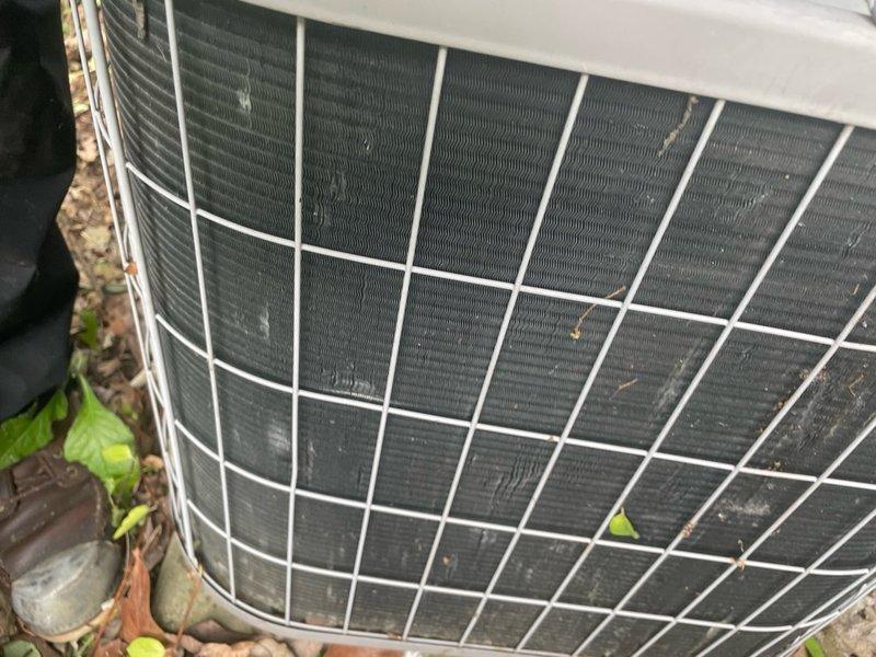 Performed comprehensive cooling season tune-up on 10-year-old residential air conditioning system located at front of property. Upon arrival, found condenser coils heavily obstructed with leaves, twigs, and accumulated debris lodged between fins. Removed debris from coil surfaces, connected refrigerant gauge manifold to service ports, and verified system pressures and operating temperatures. Completed standard preventive maintenance procedures including electrical connections inspection, capacitor testing, and overall system performance evaluation. Unit returned to normal operating condition with improved airflow through cleaned condenser coils.