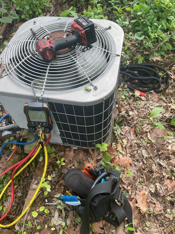 Performed comprehensive cooling season tune-up on 10-year-old residential air conditioning system located at front of property. Upon arrival, found condenser coils heavily obstructed with leaves, twigs, and accumulated debris lodged between fins. Removed debris from coil surfaces, connected refrigerant gauge manifold to service ports, and verified system pressures and operating temperatures. Completed standard preventive maintenance procedures including electrical connections inspection, capacitor testing, and overall system performance evaluation. Unit returned to normal operating condition with improved airflow through cleaned condenser coils.