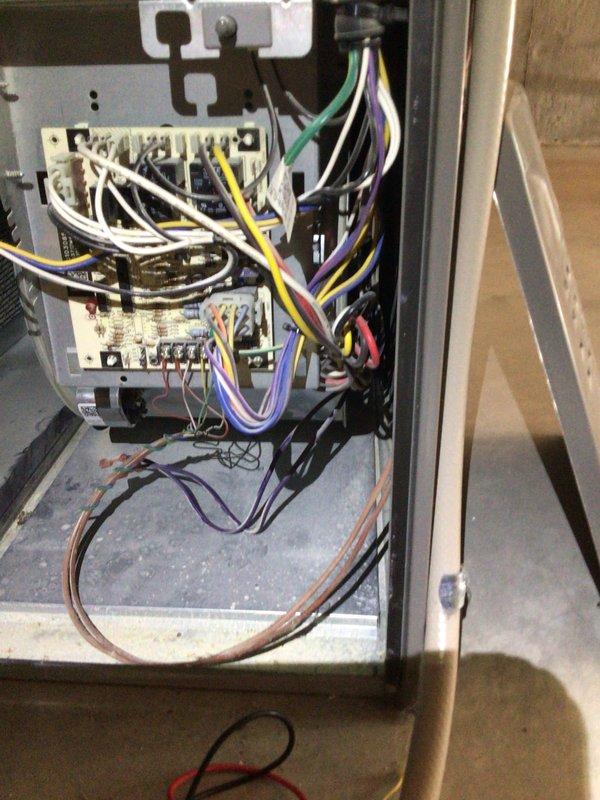 Completed comprehensive tune-up on 8-year-old residential air conditioning unit located at ground level with indoor air handler in basement. Performed electrical diagnostics using digital multimeter to verify proper voltage and amperage at control panel, inspected all electrical connections and contactors within control cabinet, and documented system conditions with photos. All components tested within normal operating parameters and unit returned to service.