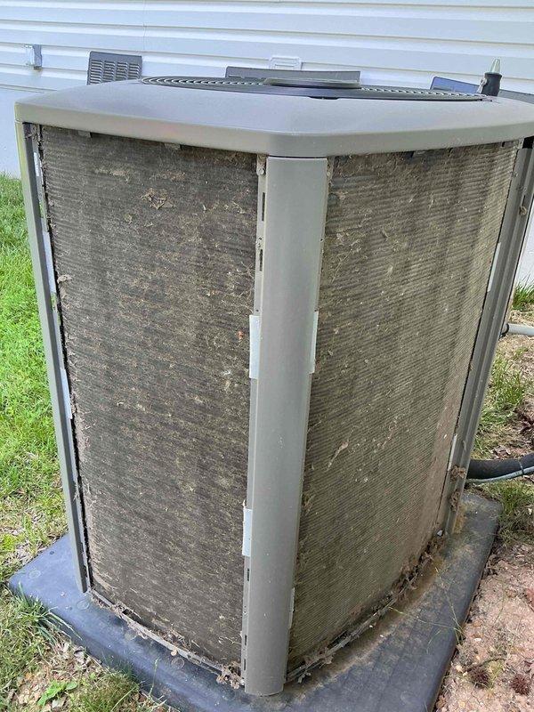 Completed comprehensive cooling season tune-up on 8-year-old ground-level AC condenser unit. Upon arrival, found condenser coils heavily contaminated with dirt, dust, and debris accumulation, significantly restricting airflow through both accessible sides of the unit. Performed thorough coil cleaning to restore proper heat exchange efficiency, inspected all electrical connections and components, verified refrigerant pressures, tested capacitor values, and confirmed proper fan motor operation. Unit restored to optimal operating condition with improved airflow and system performance.