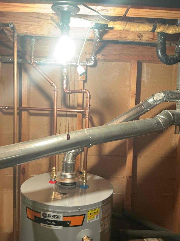Installed a 50-gallon tall State ProLine gas water heater in basement utility area with proper venting and connections. Installation included pressure relief valve, ball valve for shut-off control, and humidifier valve integration into the plumbing system. All copper piping connections were completed to manufacturer specifications, unit was tested for proper operation, and installation complies with local municipal code requirements.
