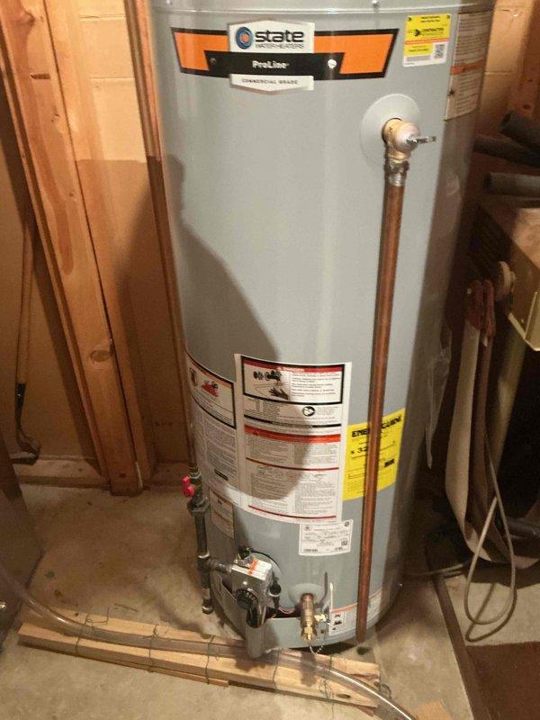Installed a 50-gallon tall State ProLine gas water heater in basement utility area with proper venting and connections. Installation included pressure relief valve, ball valve for shut-off control, and humidifier valve integration into the plumbing system. All copper piping connections were completed to manufacturer specifications, unit was tested for proper operation, and installation complies with local municipal code requirements.