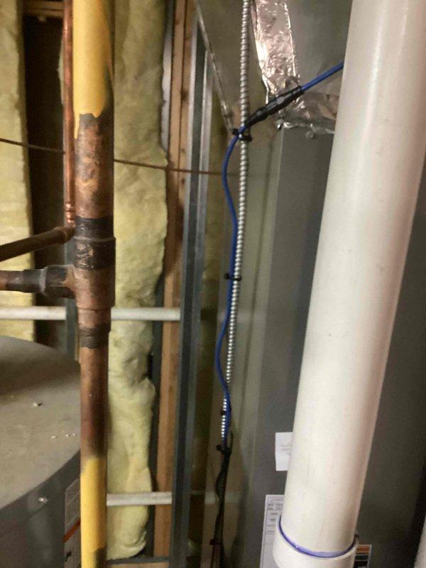 Completed installation of blue condensate drain tubing and performed thorough cleaning of evaporator coil. Routed new drain line through wall cavity alongside existing utility infrastructure and secured properly with mounting clips. Evaporator coil was cleaned to restore optimal heat transfer efficiency and system performance.