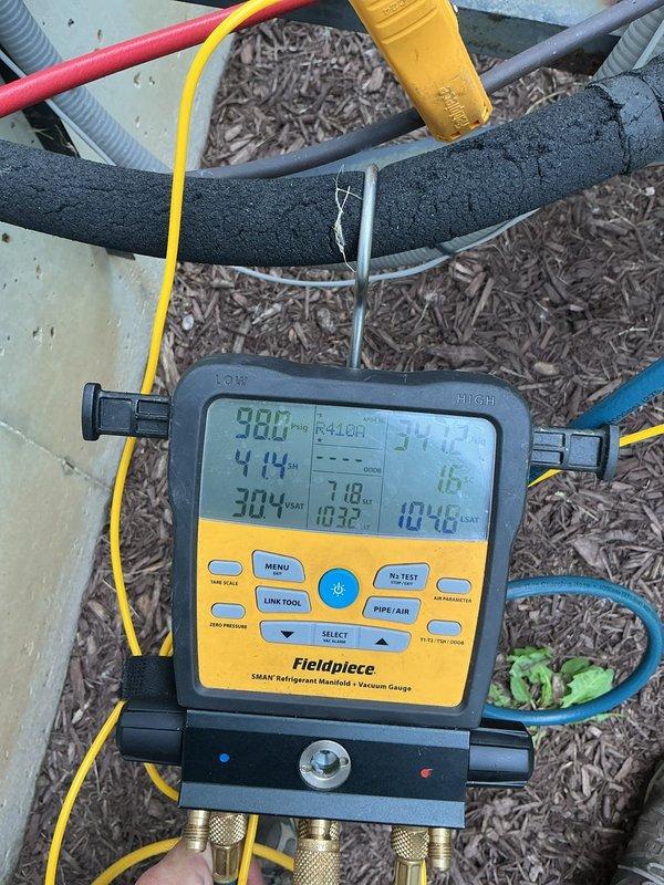 Responded to no cooling complaint on residential split system located in side yard. Upon arrival, performed complete system diagnostics using refrigerant manifold gauge set to measure operating pressures and temperatures. System found to have inadequate airflow due to restricted return air grille with significant dust and debris accumulation. Cleaned return air grille, restored proper airflow, and verified system operating within normal parameters.