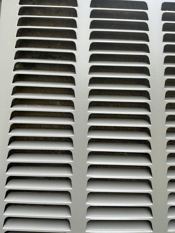 Responded to no cooling complaint on residential split system located in side yard. Upon arrival, performed complete system diagnostics using refrigerant manifold gauge set to measure operating pressures and temperatures. System found to have inadequate airflow due to restricted return air grille with significant dust and debris accumulation. Cleaned return air grille, restored proper airflow, and verified system operating within normal parameters.