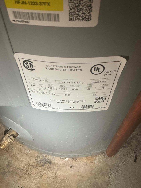 Responded to no hot water condition in basement. Completed warranty replacement of failed water heater with new AO Smith ProLine 50-gallon electric tall water heater model ENT 50 130. Removed old unit and retrieved warranty sticker for reimbursement processing. Installed new unit with proper connections to existing copper supply lines, pressure relief valve with discharge pipe, and electrical connections per manufacturer specifications. Verified all plumbing connections secure and system operational upon completion.