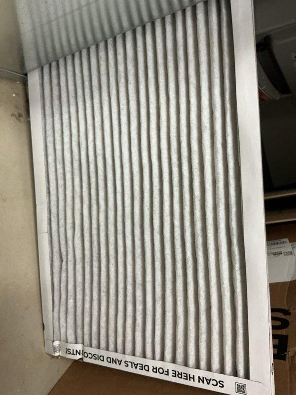 Responded to no cool call on ground-level condenser unit. Found outdoor coil completely blocked with dense accumulation of dirt, dust, lint, and cottonwood debris, restricting all airflow and preventing proper heat rejection. Cleaned condenser coil thoroughly, removing heavy debris buildup from exterior fins. Replaced dirty indoor air filter. Restored unit to normal operation with proper airflow and cooling capacity.