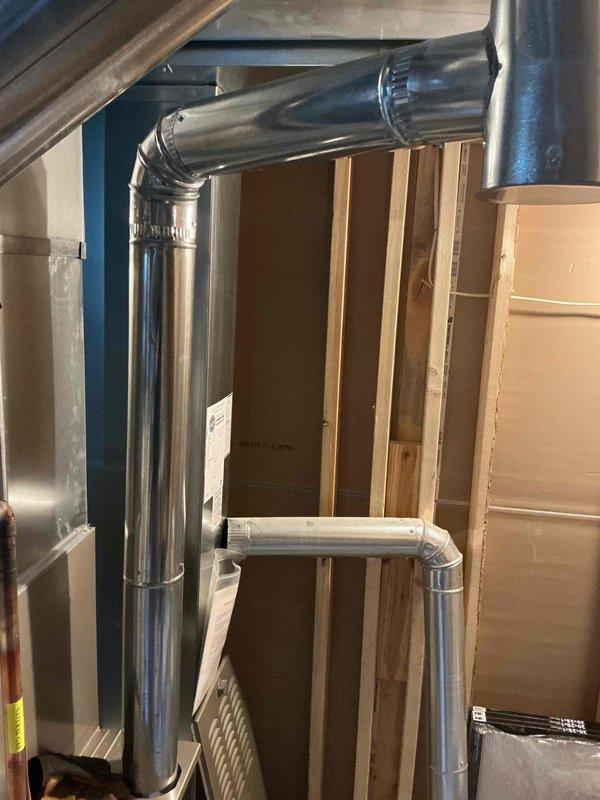 Completed repair of damaged flue pipe system for water heater and HVAC equipment. Replaced deteriorated sections with new 4" ductwork components, including one elbow fitting and three straight pipe sections. All connections were properly secured and sealed to ensure safe exhaust ventilation, and system was tested to verify proper operation.