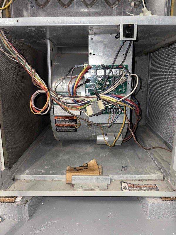 Completed cooling tune-up on outdoor condensing unit over 10 years old located in side yard. Performed standard maintenance protocol including inspection of condenser coil which showed significant accumulation of dirt and pollen with visible yellow streaking throughout fins, inspected internal air handler components and control board assembly, verified all electrical connections and refrigerant lines, and documented system condition with photos. Unit operational upon completion of service.