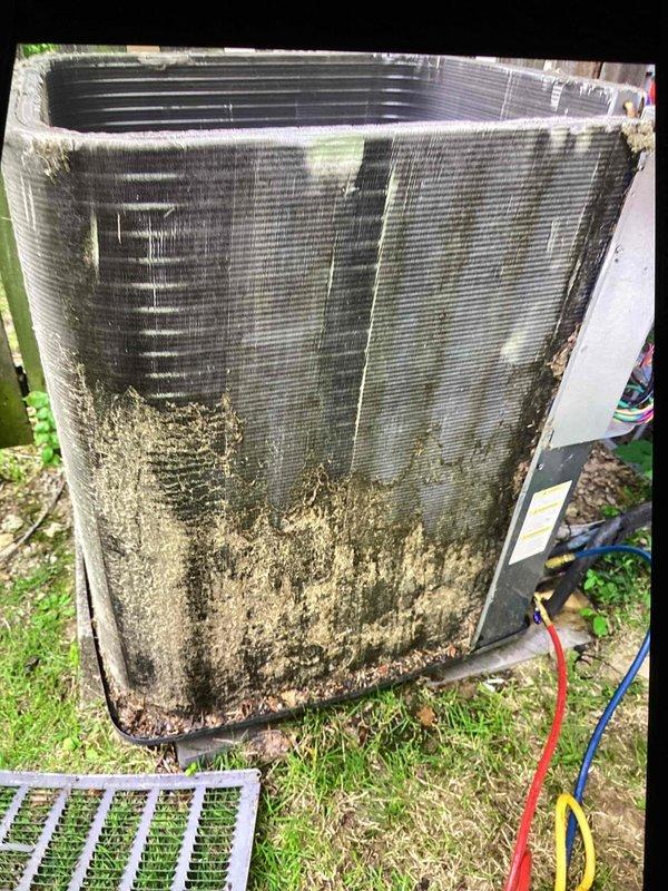 Responded to callback for system not cooling following recent maintenance and leak search. Upon arrival, found outdoor condenser unit with extensive dirt, debris, and biological growth accumulation on exterior panels and coil surfaces. Heavy contamination was restricting airflow through condenser coils, significantly impacting heat transfer efficiency and system performance. Performed thorough cleaning of condenser coil and exterior components to restore proper airflow and cooling capacity. Unit now operating within normal parameters.