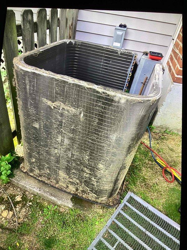 Responded to callback for system not cooling following recent maintenance and leak search. Upon arrival, found outdoor condenser unit with extensive dirt, debris, and biological growth accumulation on exterior panels and coil surfaces. Heavy contamination was restricting airflow through condenser coils, significantly impacting heat transfer efficiency and system performance. Performed thorough cleaning of condenser coil and exterior components to restore proper airflow and cooling capacity. Unit now operating within normal parameters.