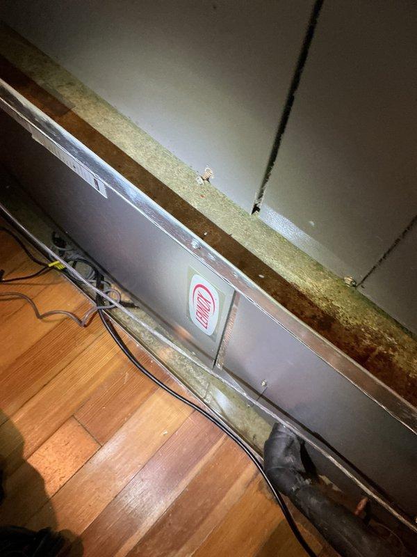 Responded to emergency service call for two 13-year-old attic-mounted air handlers experiencing drain pan overflow. Upon inspection, found both units' condensate drain lines were blocked, causing drain pans to fill and overflow overnight. Cleared obstructions from primary and secondary drain lines on both units, tested drainage flow with gauge equipment to verify proper operation, and confirmed pans were draining correctly before departure.