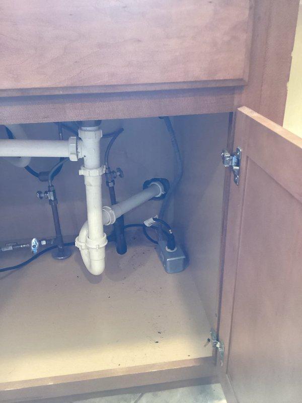 Completed final phase of permitted plumbing installation following drywall finishing work. Installed toilet fixture and applied caulking around base to ensure proper seal and finished appearance. Performed water test on drain stack to verify system integrity for municipal inspection compliance. Verified all rough-in plumbing connections, including vertical drain stack and associated trap assemblies beneath cabinet fixtures, were properly secured and functioning. This work fulfilled the remaining scope of the original estimate and brought the installation to completion per permit requirements.