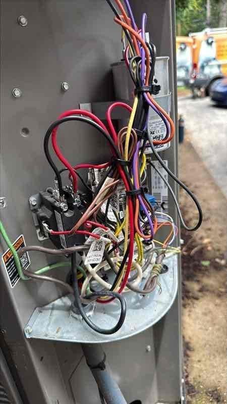 Replaced failed compressor on outdoor condensing unit with serial number 1923d43199. Removed defective compressor, installed new Lennox replacement unit with updated electrical plug, verified all wiring connections within control panel, and documented both old and new compressor nameplate information per service requirements. System restored to full operational status with backup system available during repair period.