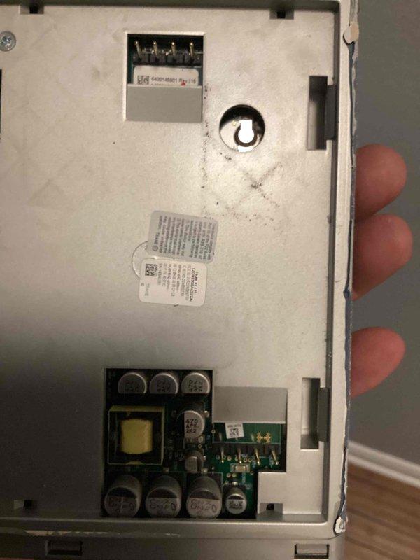 Responded to no cooling complaint on 12-year-old residential air conditioning system. Upon arrival, performed diagnostic evaluation of the system. Inspected thermostat control unit and removed cover to access internal components. Examined circuit board, wiring connections, and electrical terminals for proper operation and signs of failure. Photographed internal components including PCB, transformer, capacitors, and control circuitry to document condition. Identified issues with thermostat control module affecting system operation. Completed necessary repairs to restore cooling function and verified proper system operation before departure.