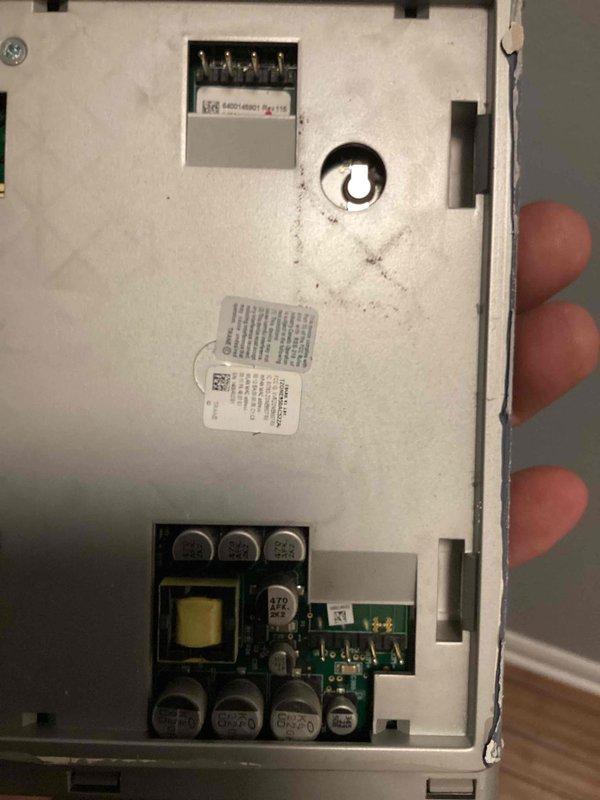 Responded to no cooling complaint on 12-year-old residential air conditioning system. Upon arrival, performed diagnostic evaluation of the system. Inspected thermostat control unit and removed cover to access internal components. Examined circuit board, wiring connections, and electrical terminals for proper operation and signs of failure. Photographed internal components including PCB, transformer, capacitors, and control circuitry to document condition. Identified issues with thermostat control module affecting system operation. Completed necessary repairs to restore cooling function and verified proper system operation before departure.