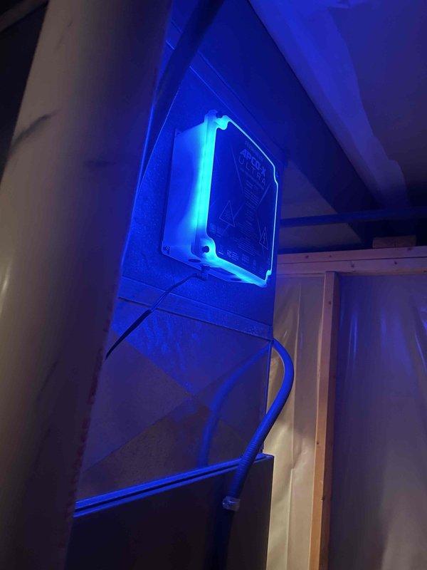 Completed installation of APCO X air purification system on main HVAC unit and Blue Tube UV light system on downflow unit, with both devices mounted at evaporator coil locations. Both UV air treatment systems were wired, secured, and tested for proper operation to provide whole-home air purification and microbial control.