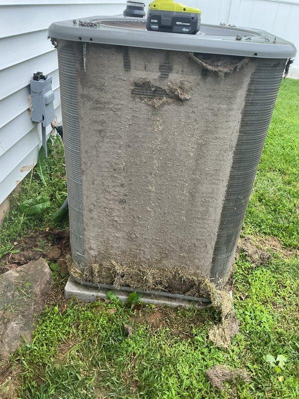 Completed tune-up on single ground-mounted AC condenser unit. Unit exhibited heavy dust and debris accumulation on coil surfaces and significant deterioration of exterior insulation panel with cracking and material breakdown exposing underlying heat exchanger fins. Performed standard maintenance procedures including system inspection, cleaning of accessible components, and operational testing with diagnostic equipment to verify proper function.