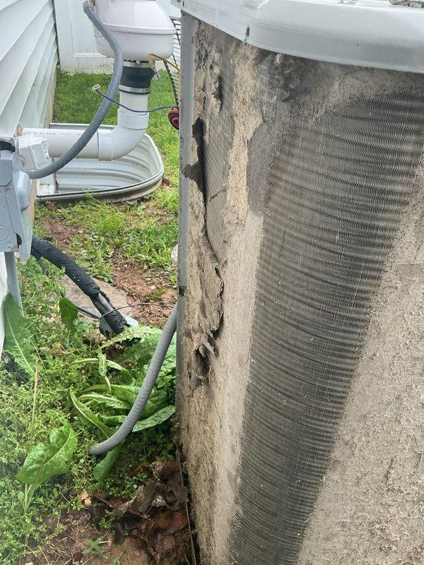 Completed tune-up on single ground-mounted AC condenser unit. Unit exhibited heavy dust and debris accumulation on coil surfaces and significant deterioration of exterior insulation panel with cracking and material breakdown exposing underlying heat exchanger fins. Performed standard maintenance procedures including system inspection, cleaning of accessible components, and operational testing with diagnostic equipment to verify proper function.