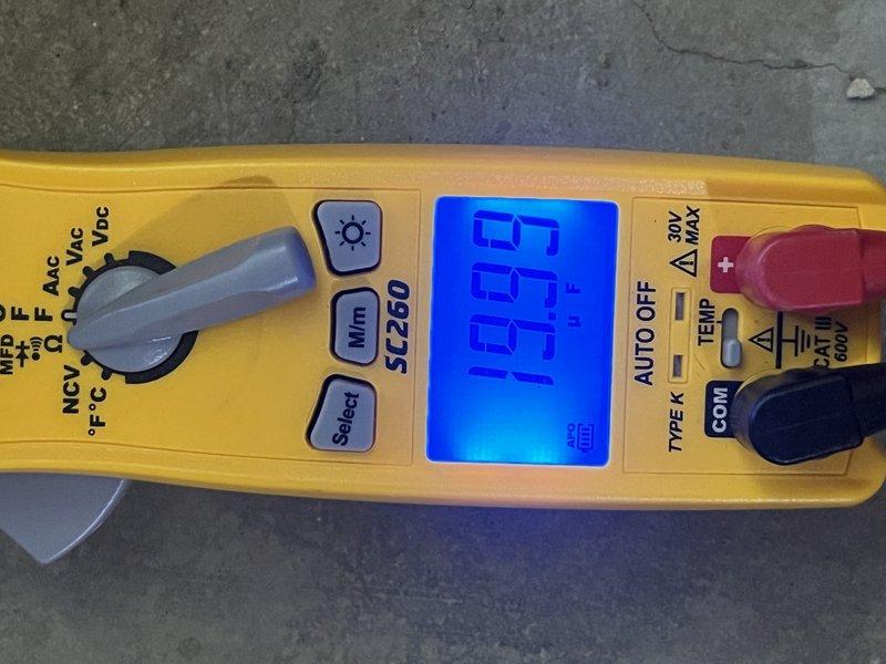 Responded to no cooling complaint on 12-year-old Goodman AC system that ran continuously overnight without providing adequate cooling. Upon arrival, performed diagnostic testing using digital thermometer and clamp meter to assess system performance and electrical parameters. Measured temperature readings at evaporator coil showing 90.6°F, indicating insufficient heat transfer. Tested electrical components including amperage draw and voltage levels to identify potential compressor or refrigerant issues. System was shut down by customer prior to arrival due to continuous runtime without cooling output. Documented findings with diagnostic measurements and photos for service records.