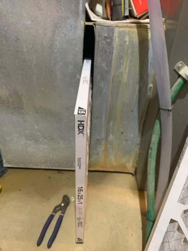 Responded to recall for improperly installed air filter that was jammed and deteriorating in basement HVAC unit. Removed damaged filter showing significant breakdown of filter media and replaced with correctly sized filter ensuring proper fit within track system. Verified new filter installation with adequate clearance and secure positioning to prevent future jamming issues.