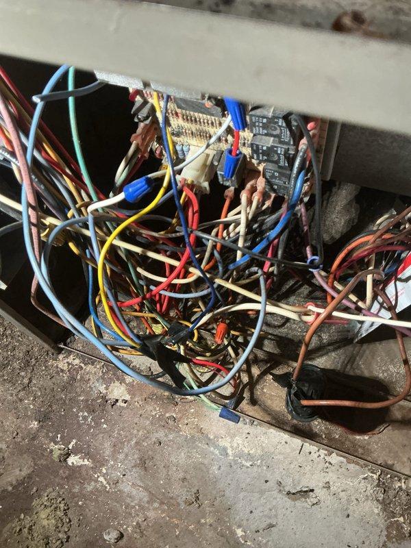 Responded to no cooling call for 27-year-old central air conditioning system that had been non-operational for five weeks. Upon arrival, coordinated entry time per customer request due to household circumstances. Performed comprehensive system diagnostics on outdoor condensing unit and associated electrical controls. Inspected control board assembly, wiring connections, and electrical components within equipment enclosure. Evaluated multi-circuit control system with various power and control wiring. Assessed overall system condition including mechanical components, refrigerant circuit accessibility, and electrical infrastructure in basement utility area. Documented system configuration and current operating status through detailed photographic evidence of control panel, wiring assembly, and installation environment for service records and future reference.