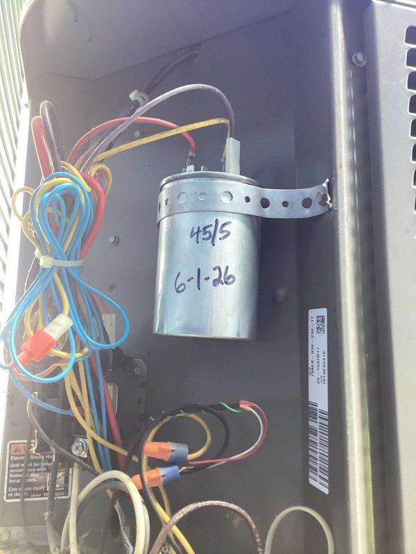 Responded to no cooling complaint on basement-located HVAC unit. Upon inspection, found failed dual run capacitor (45/5 MFD) dated 6-1-26. Verified system pressures and temperatures using refrigerant manifold gauges, confirming inadequate cooling performance due to capacitor failure. Replaced defective capacitor with OEM equivalent, restored proper electrical connections, and tested system operation. Unit now cooling properly with pressures and superheat within manufacturer specifications.