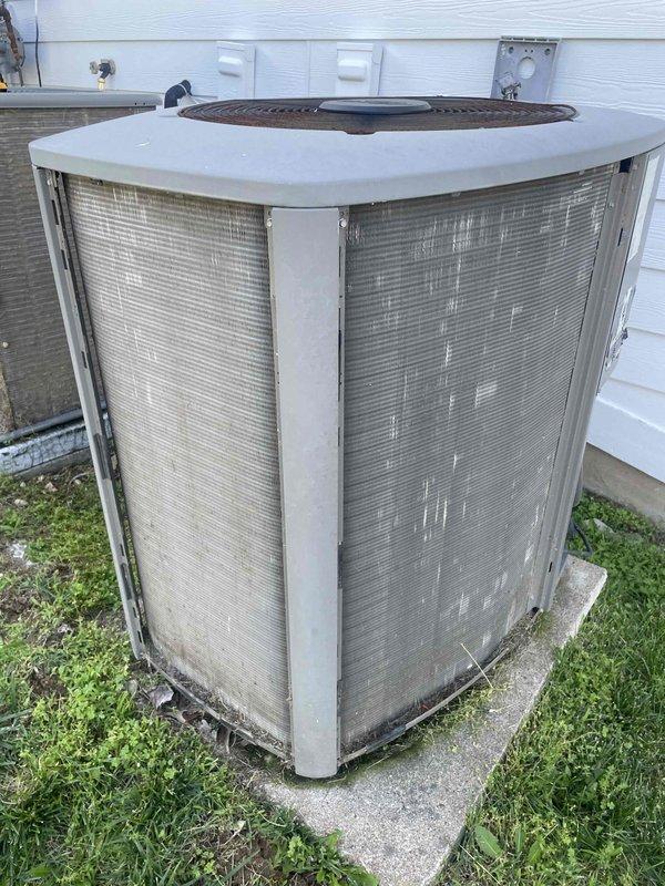 Performed comprehensive cooling maintenance on a 9-year-old residential air conditioning system experiencing inadequate cooling capacity and electrical issues causing lights to dim at startup. Completed full system inspection including visual examination of outdoor condenser unit, electrical components, contactor, dual capacitors, and wiring connections. Addressed reported concerns of loud startup noise and insufficient cooling performance. Checked refrigerant levels, tested electrical draw, and evaluated compressor operation. Inspected condenser coils, verified proper airflow through mesh grilles, and assessed overall system functionality. Documented equipment condition with photos showing capacitor configuration, electrical connections, and exterior unit placement on concrete pad with visible weathering consistent with system age.