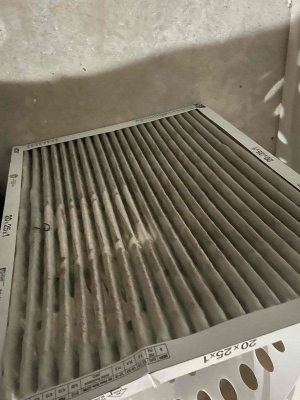 Completed comprehensive tune-up service on single ground-level air conditioning condenser unit. Performed standard maintenance protocol including inspection of exterior components, electrical connections, and refrigerant lines. Evaluated and replaced heavily soiled 20x25x1 air filter showing significant dust accumulation and reduced airflow capacity. Unit exhibited considerable weathering and exterior staining consistent with extended service life, though all mechanical and electrical components were verified operational during inspection.