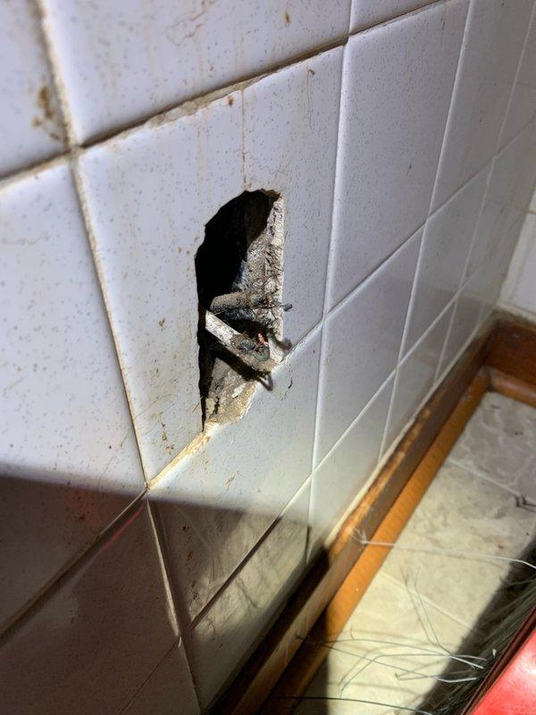 Responded to report of exposed wiring in kitchen area. Upon inspection, discovered open electrical junction box recessed in wall with active wire connections exposed through damaged tile and drywall. Identified two wire connectors (wire nuts) joining circuit conductors within box showing signs of age and accumulated debris. Verified wire connections were secure and properly terminated, confirmed no exposed bare conductors were making contact, and ensured all splices were contained within approved junction box with adequate wire fill capacity. Electrical hazard was mitigated by securing connections and providing recommendations for proper cover plate installation to enclose junction box per code requirements.
