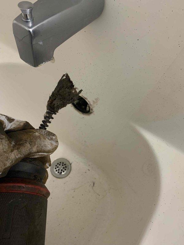 Responded to bathroom sink drain obstruction caused by lodged plunger. Successfully removed stuck plunger from drain assembly and extracted corroded drain hardware components including deteriorated pop-up assembly, spring mechanism, and heavily oxidized valve fittings. Cleared drain line and restored full drainage functionality without requiring additional cabling services.