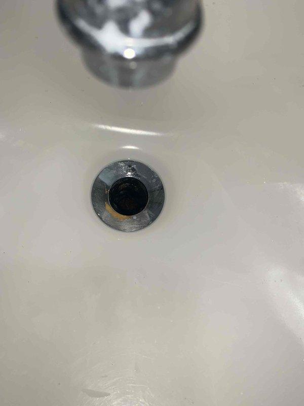 Responded to bathroom sink drain obstruction caused by lodged plunger. Successfully removed stuck plunger from drain assembly and extracted corroded drain hardware components including deteriorated pop-up assembly, spring mechanism, and heavily oxidized valve fittings. Cleared drain line and restored full drainage functionality without requiring additional cabling services.