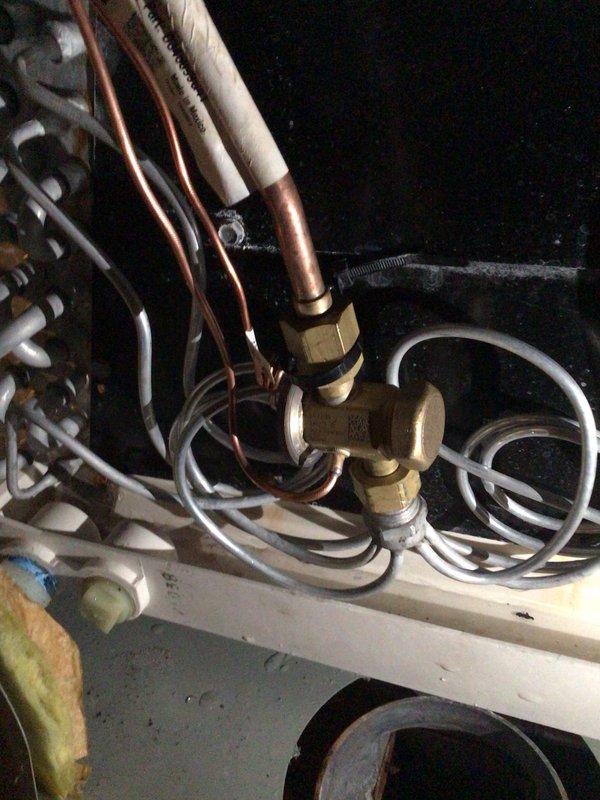 Replaced defective thermal expansion valve (TXV) on HVAC system. Removed failed component from refrigerant line assembly, installed new TXV with proper brass fittings, and reconnected copper refrigerant lines. System tested and operational upon completion, with old part disposed of per protocol.