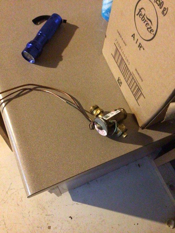 Replaced defective thermal expansion valve (TXV) on HVAC system. Removed failed component from refrigerant line assembly, installed new TXV with proper brass fittings, and reconnected copper refrigerant lines. System tested and operational upon completion, with old part disposed of per protocol.
