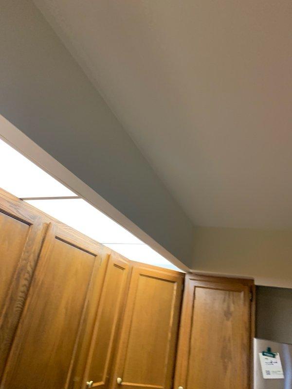 Completed installation of LED lighting fixtures in kitchen area. Installed 8-12 new LED light fixtures in soffit space above cabinetry, providing enhanced illumination for the workspace. All fixtures tested and confirmed operational upon completion.