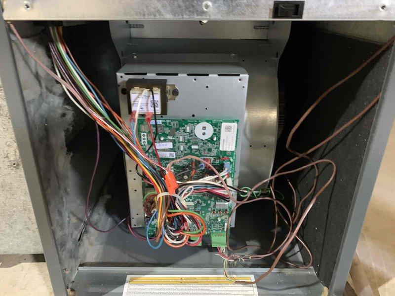 Completed cooling system tune-up on single residential unit located in side yard. Performed comprehensive maintenance inspection revealing significant debris and dirt accumulation on evaporator coil fins, particularly in lower sections with dark discoloration indicating restricted airflow. Inspected electrical components, control boards, and wiring connections within unit compartment; all connections secure and functioning properly. Verified proper refrigerant line integrity and system operation. Unit is under 10 years old and operational following service.
