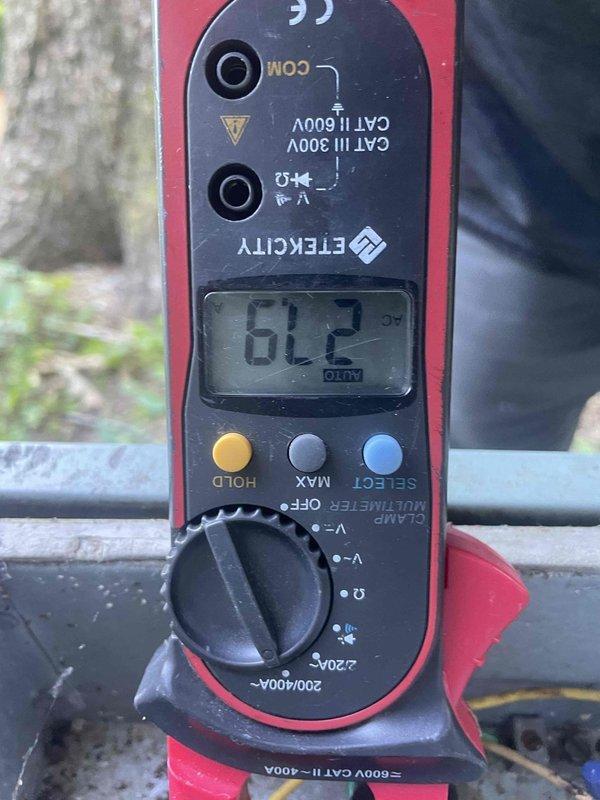 Responded to no cooling complaint on 10+ year old outdoor unit located on backside of property. Upon arrival, performed electrical diagnostics using multimeter and measured 61.2 volts at contactor, indicating failed contactor preventing compressor from receiving proper power supply. Inspected electrical disconnect box which showed significant corrosion, debris accumulation, and deteriorated wiring connections. Identified failed contactor as root cause of no cooling condition. Presented repair options to restore cooling operation.